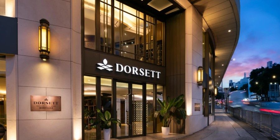 The entrance to the Dorsett Hotel Hong Kong, featuring modern architecture and welcoming signage.